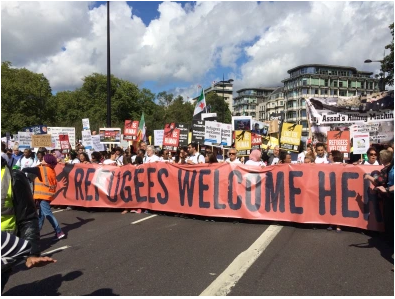 Refugees Welcome banner on solidarity march